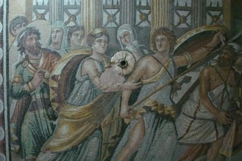 A detailed ancient mosaic depicting a scene of warriors and women adorned in classical attire.