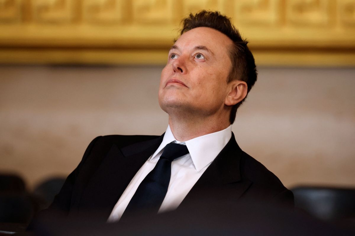 Elon Musk in a tuxedo gazing upward, in a formal setting with golden decor in the background.