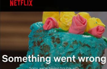 A close-up of a colorful cake topped with pink and yellow frosting flowers, with a Netflix error message displayed.