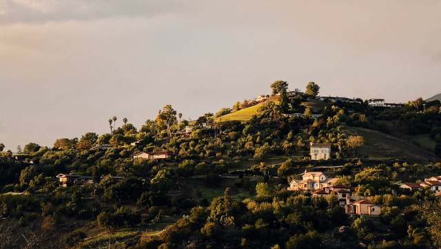 A green hill with houses.