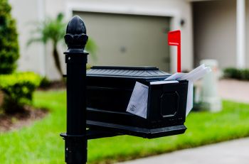 A mailbox with junk mail poking out.