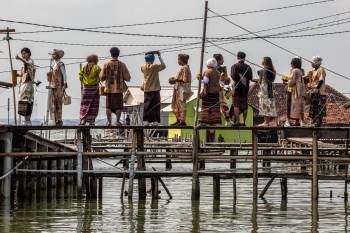 People on a bridge avoiding flooding in Central Java, Indonesia.