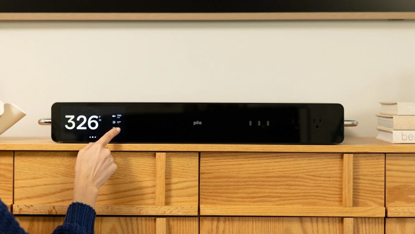A close-up of a digital display showing time and settings, with a hand adjusting the controls on a sleek black device.
