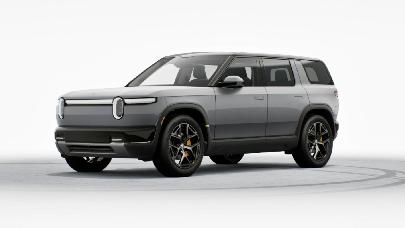 A modern electric SUV with a sleek gray design and distinctive headlights, shown against a white background.