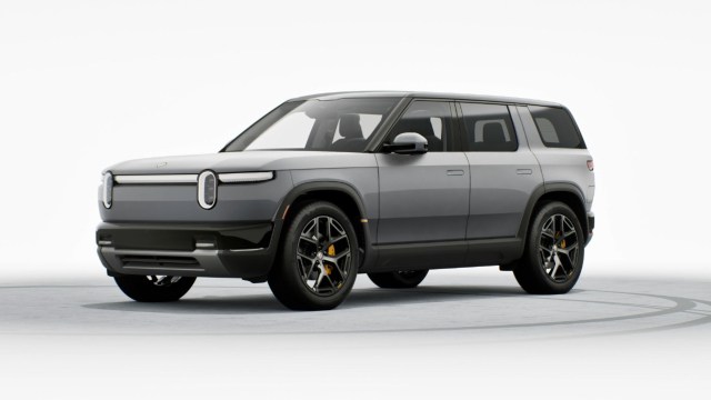 A modern electric SUV with a sleek gray design and distinctive headlights, shown against a white background.