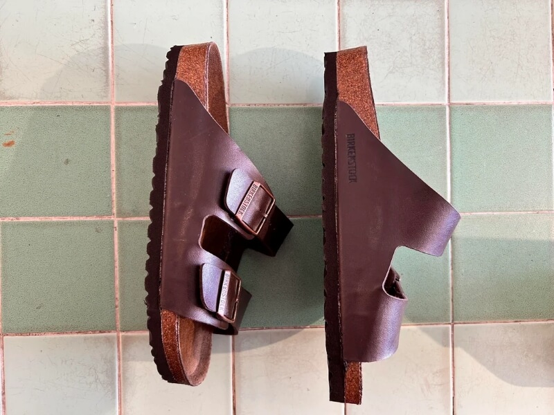 A refreshed pair of Birkenstock sandals with the original leather straps.