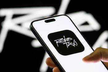 A person holds a smartphone displaying the "Robo Taxi" app logo.