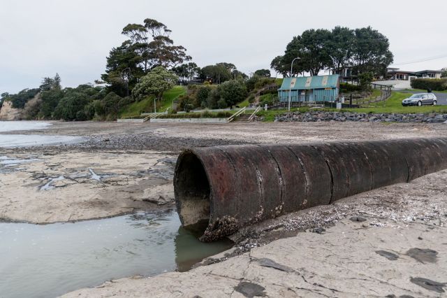 A sewage pipe on a beach.