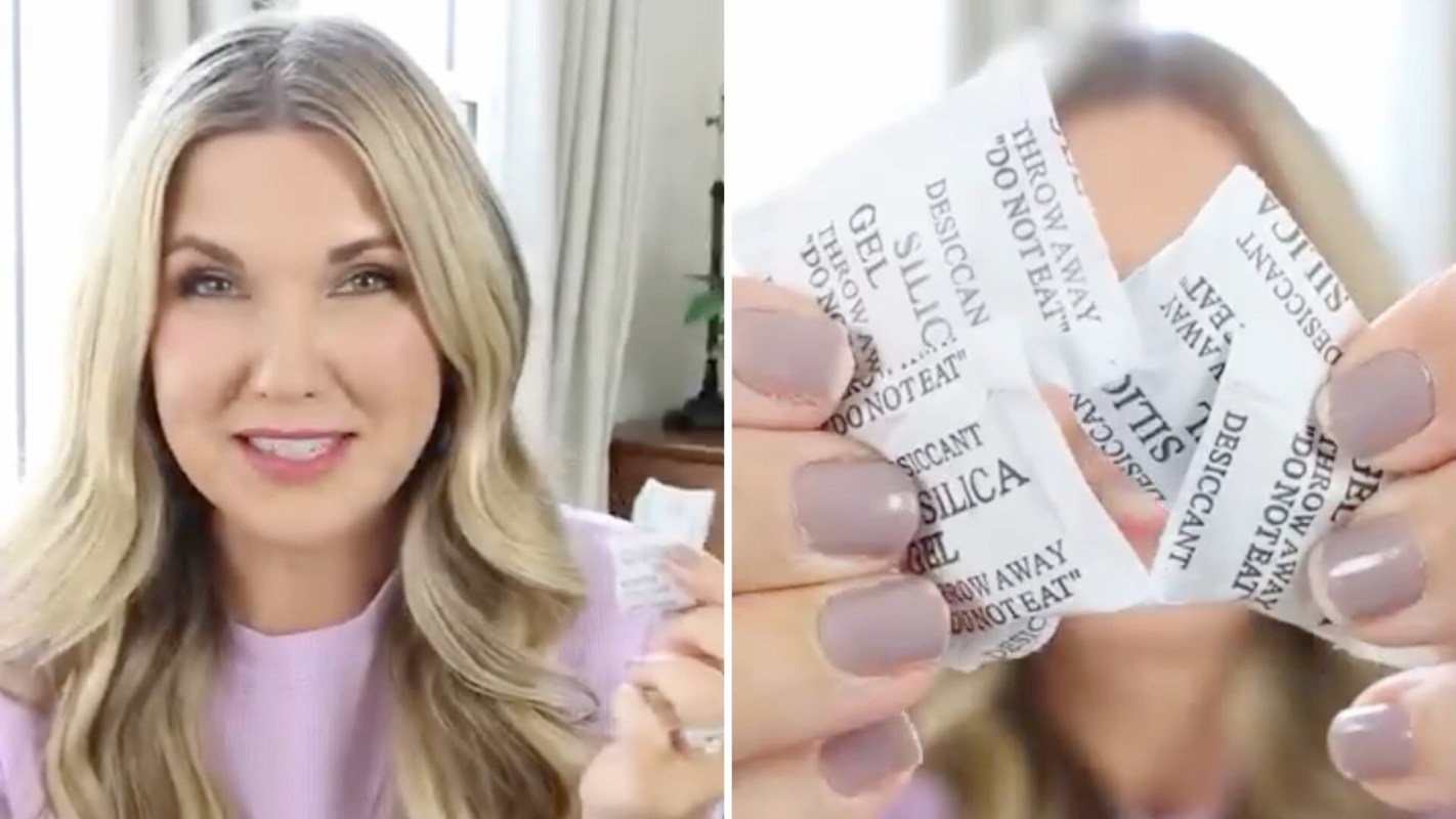 A smiling woman holds several silica gel packets, labeled "DO NOT EAT," in front of a bright background.