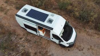 Solar panels on the roof of a white van.
