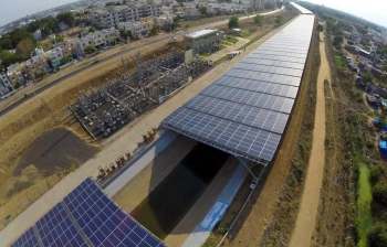 Solar panels installed over an irrigation canal.