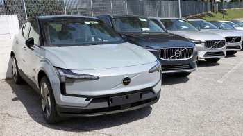Volvo vehicles, including a three-row EV SUV, at a dealership.