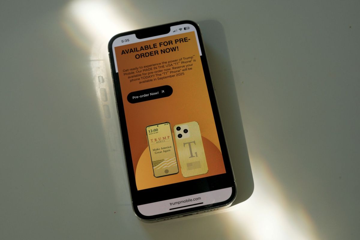 A smartphone displaying a promotional screen for pre-ordering the "T1" phone by Trump Mobile.