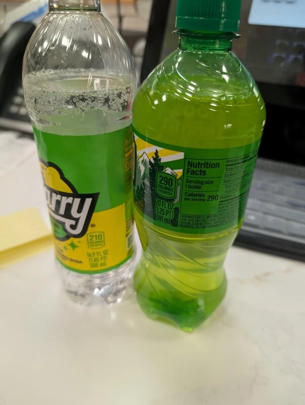 A 16-ounce plastic bottle of Starry next to a 20-ounce soda bottle. 
