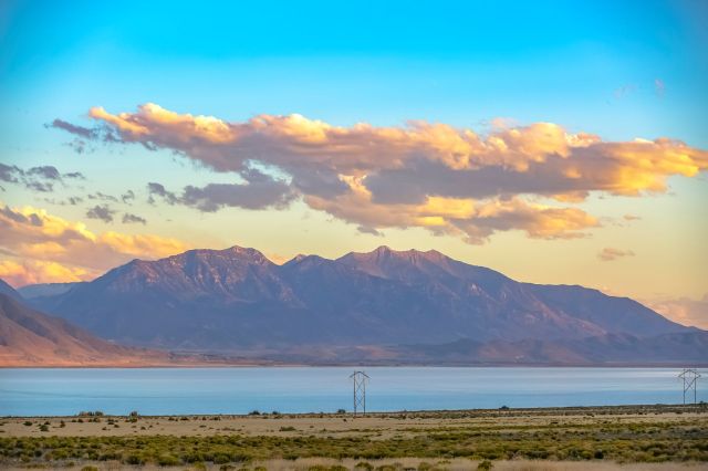 Utah Lake with a bright, partly cloudy sky.