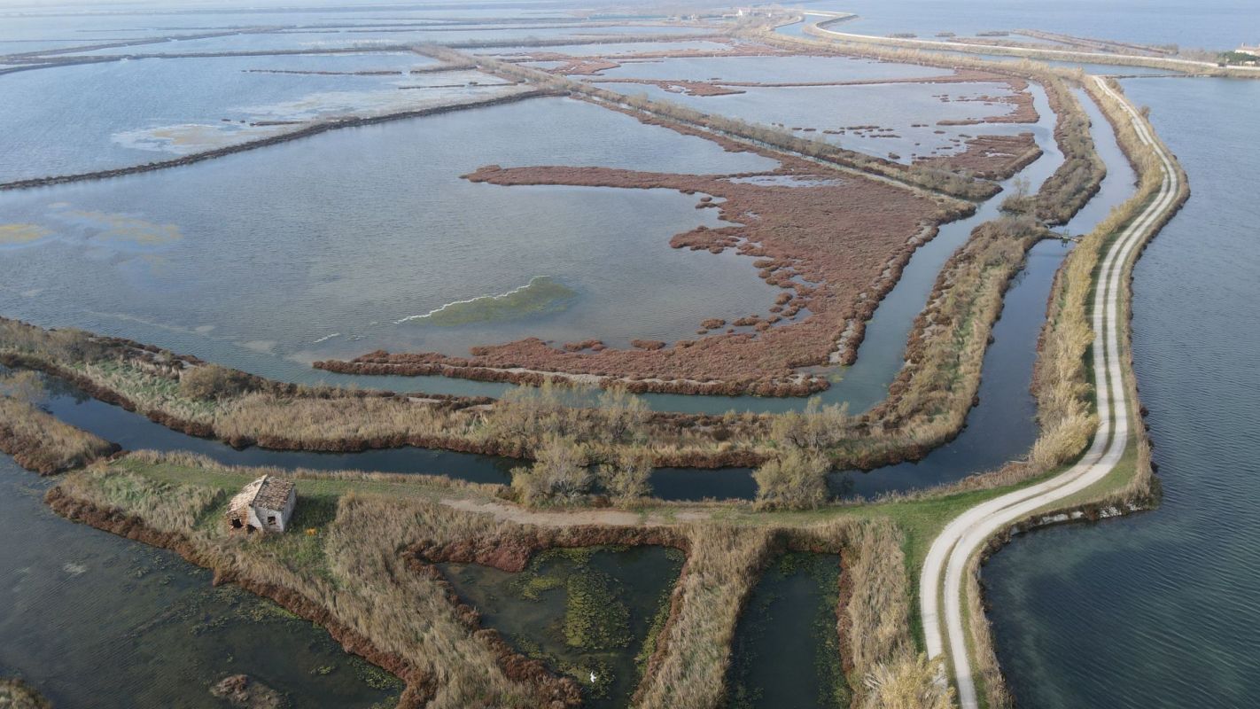 Curved land and roads around lagoon in Venice, Italy.