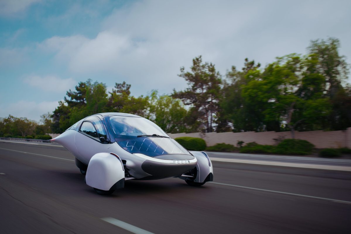 A futuristic, aerodynamic vehicle design with a sleek silver body and distinctive wheel coverings.