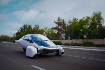 A futuristic, aerodynamic vehicle design with a sleek silver body and distinctive wheel coverings.