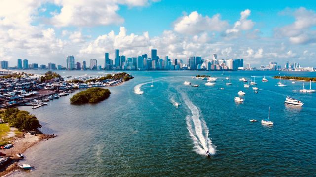 Biscayne Bay with boats in the water and the Miami skyline in the background.