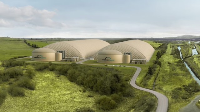 A landscape featuring two large dome structures labeled "ENERGY DOME" in a green rural setting.