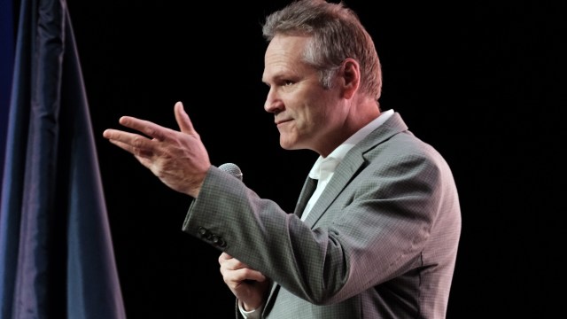 Governor Mike Dunleavy delivering a speech into a microphone.