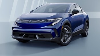 A modern blue Mitsubishi electric vehicle parked against a minimalist backdrop.