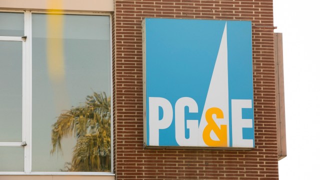 A PG&E company sign on a brick building.
