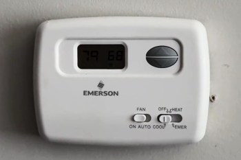 An Emerson thermostat mounted on a wall.