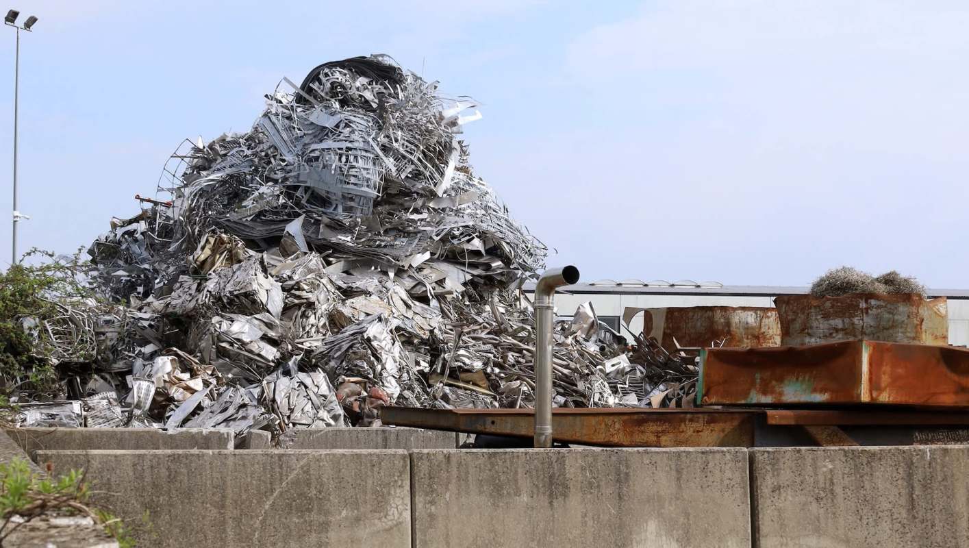 A large pile of metal at a scrapyard.