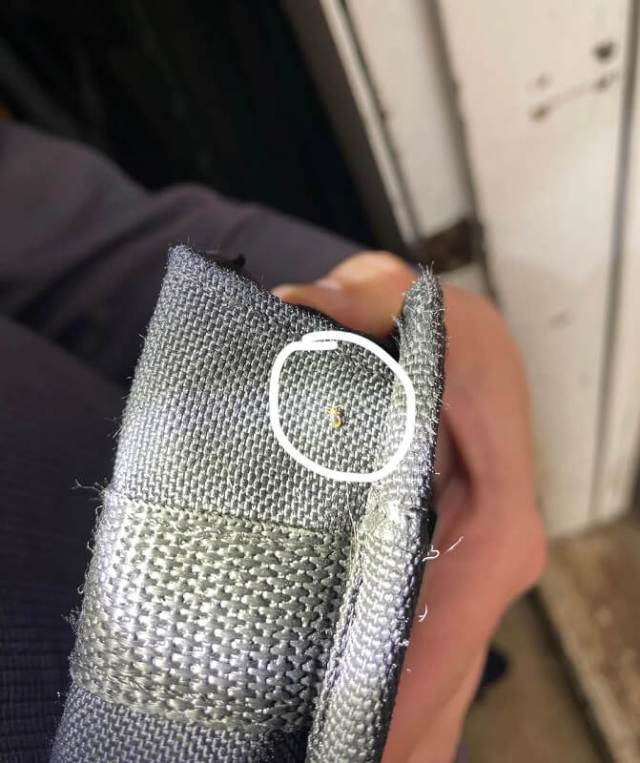 A close-up view of textured gray fabric showcasing its woven pattern and shine.