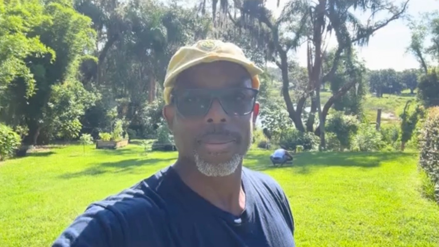Content creator Andre the Farmer in a food forest.