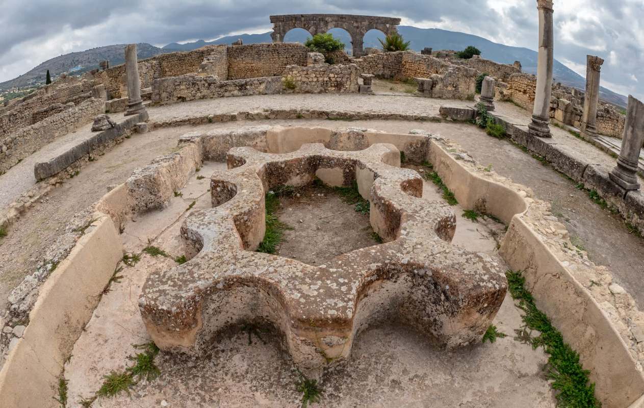 Ancient ruins featuring a stone structure shaped like a gear.