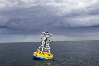 A buoy with scientific instruments floats in the ocean.