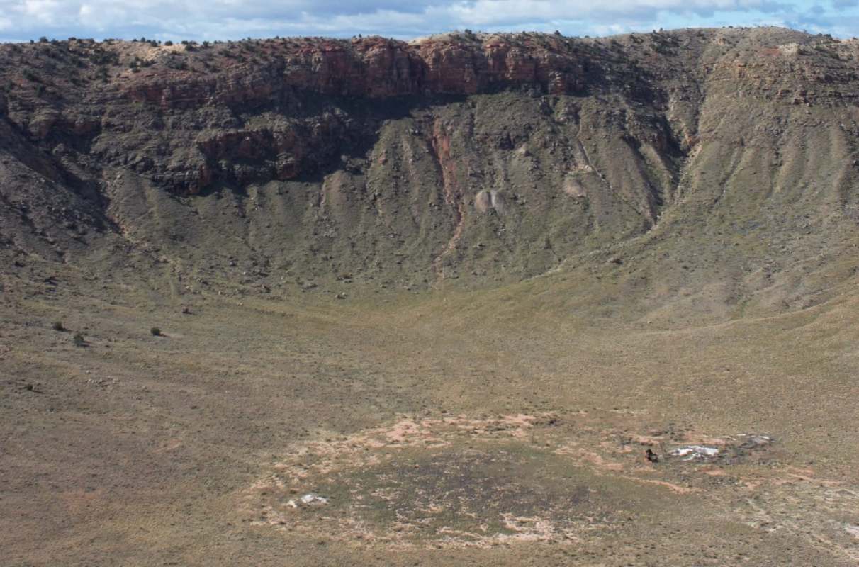 A panoramic view of a large, dry crater.