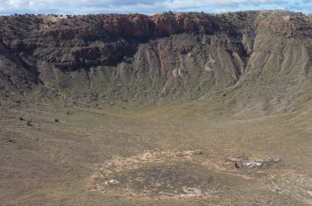 A panoramic view of a large, dry crater.