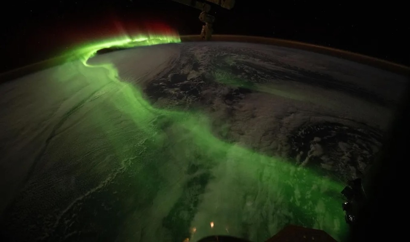 A green aurora dances over the Earth.
