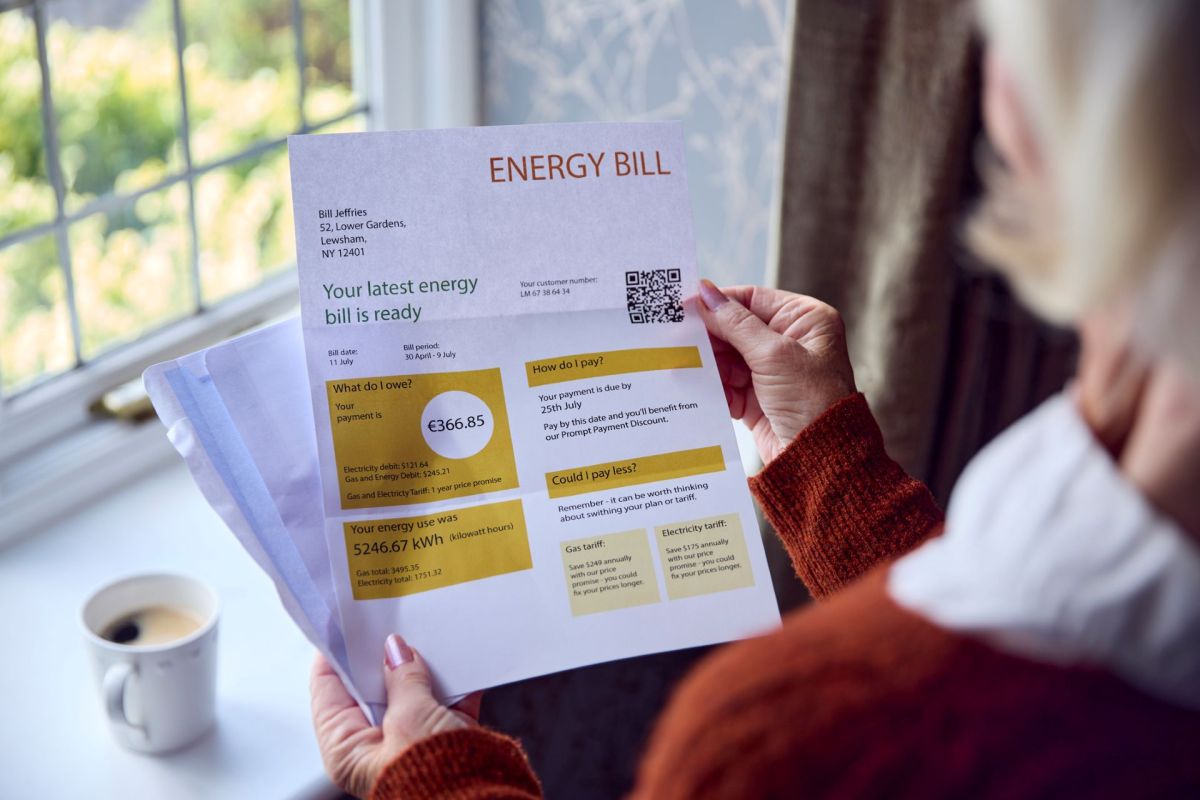 Person reviewing a monthly household energy bill.