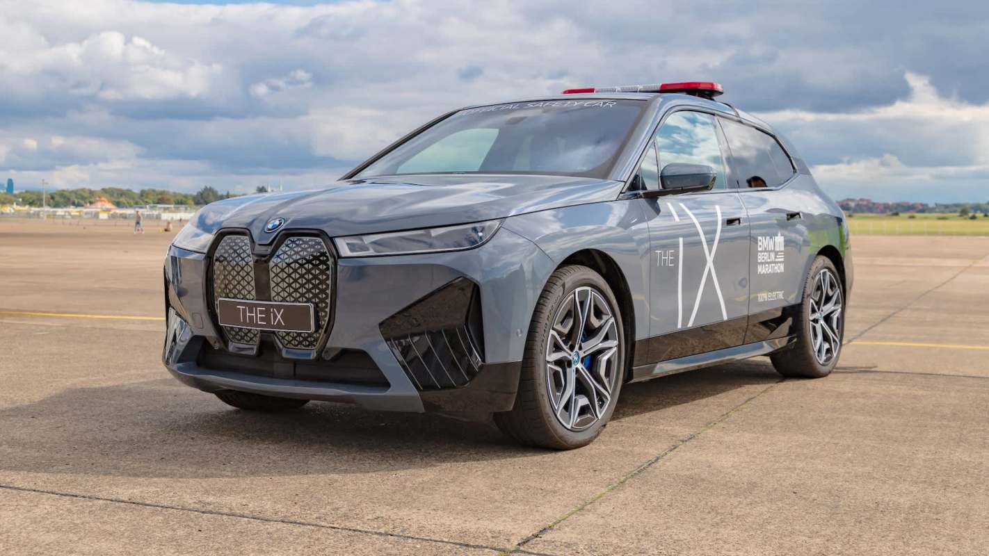 A gray BMW iX electric vehicle with a special safety decal.