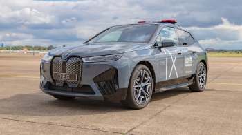 A gray BMW iX electric vehicle with a special safety decal.