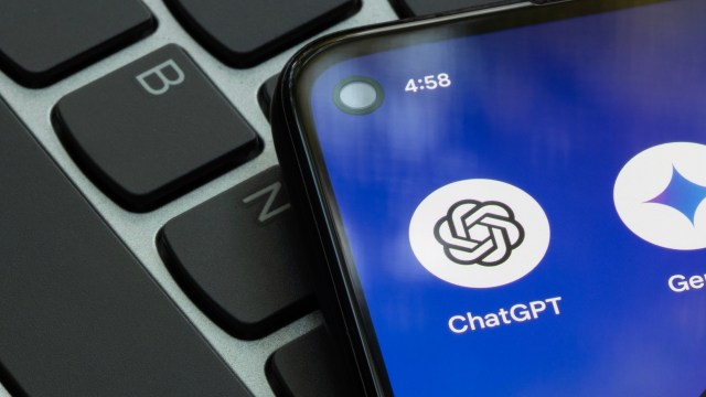 A close-up of a smartphone screen displaying the ChatGPT app icon next to a keyboard.