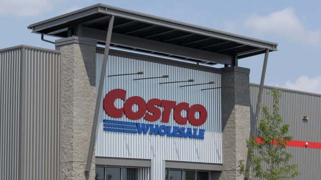 A close-up of a Costco Wholesale store sign mounted on a modern building facade.