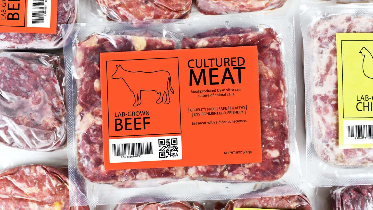 Packaging of lab-grown beef and chicken with labels highlighting cruelty-free and environmentally friendly attributes.