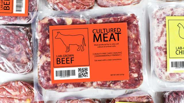 Packaging of lab-grown beef and chicken with labels highlighting cruelty-free and environmentally friendly attributes.
