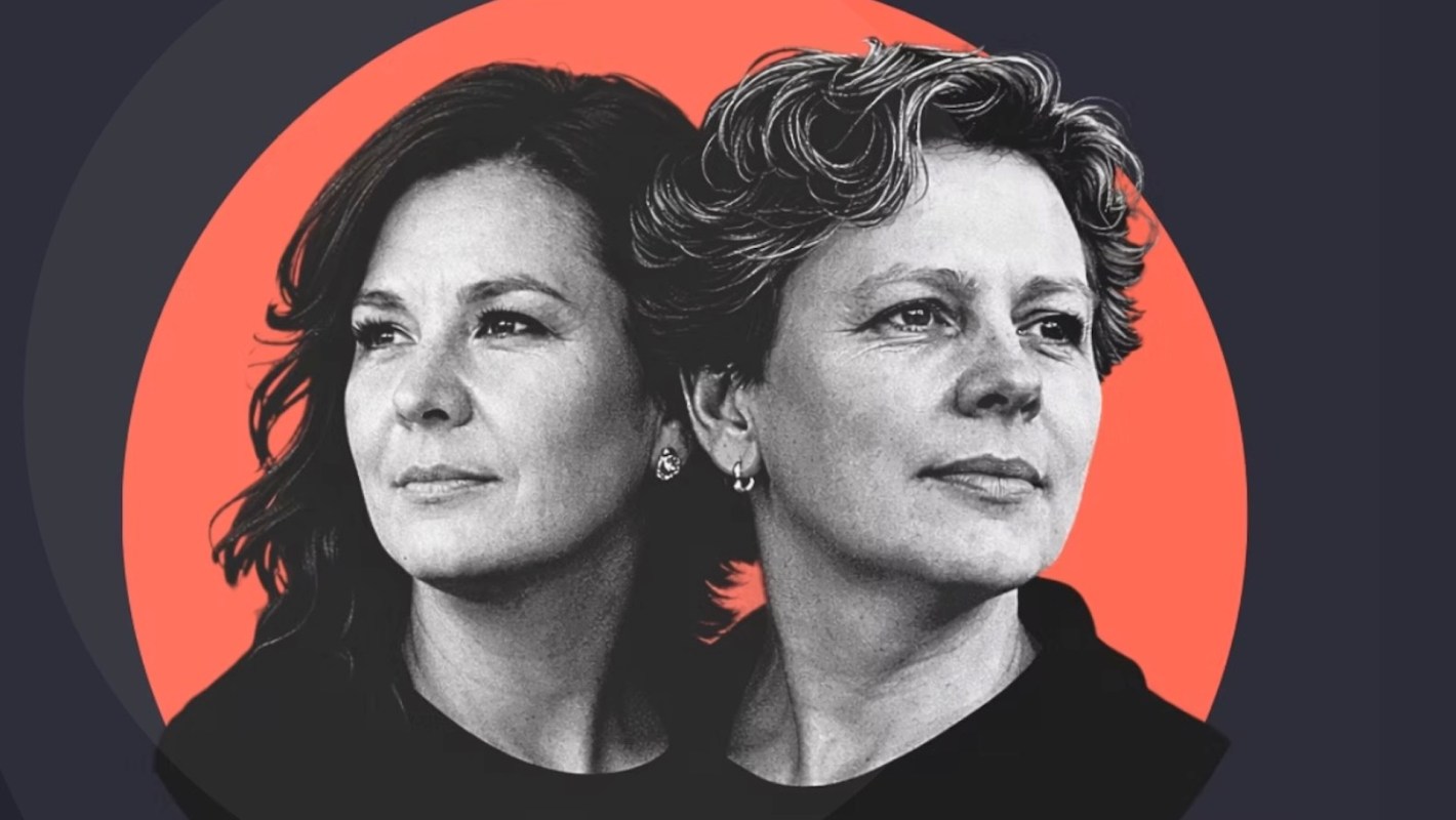 Two women with thoughtful expressions are positioned side by side against a vibrant orange-red background.