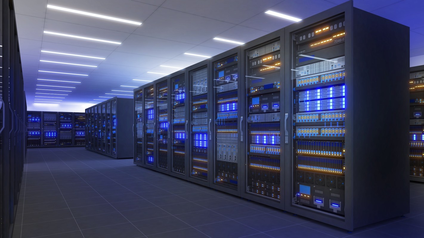A data center with rows of server racks illuminated by blue and orange lights.