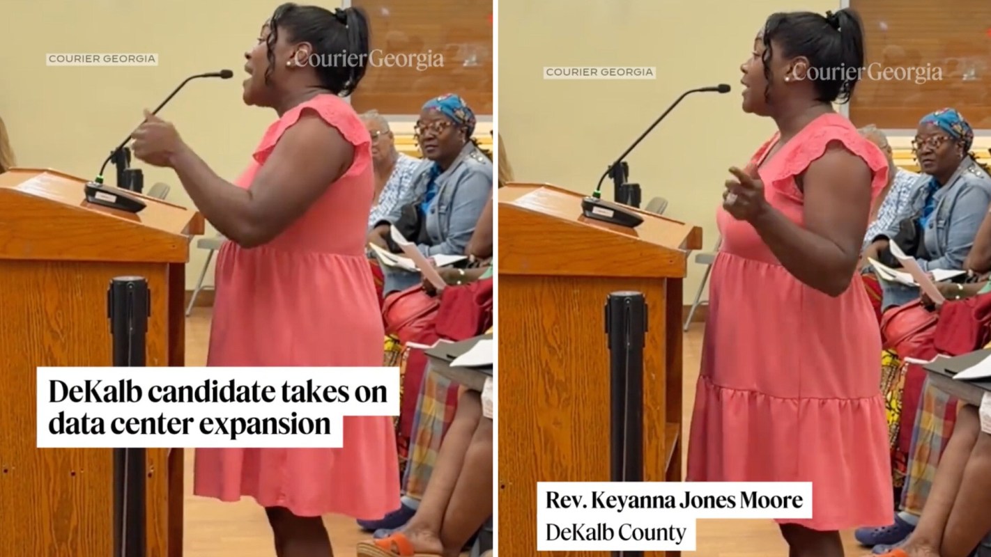 A woman in a pink dress speaks passionately at a podium during a public meeting in DeKalb County.
