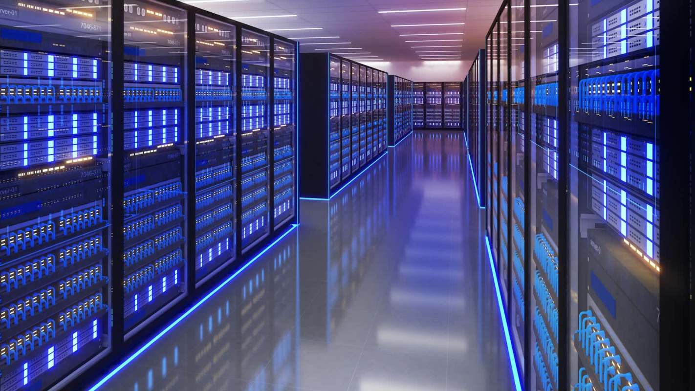 A modern server room with rows of equipment illuminated by soft blue lighting.