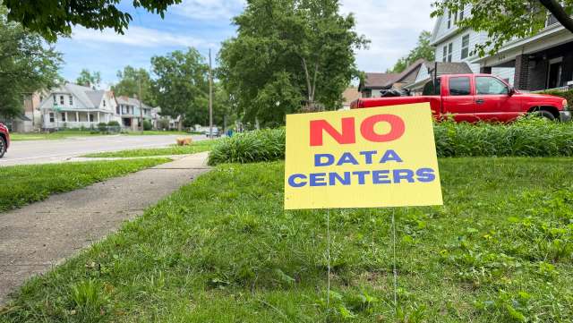 A yellow sign in a yard reads "NO DATA CENTERS."