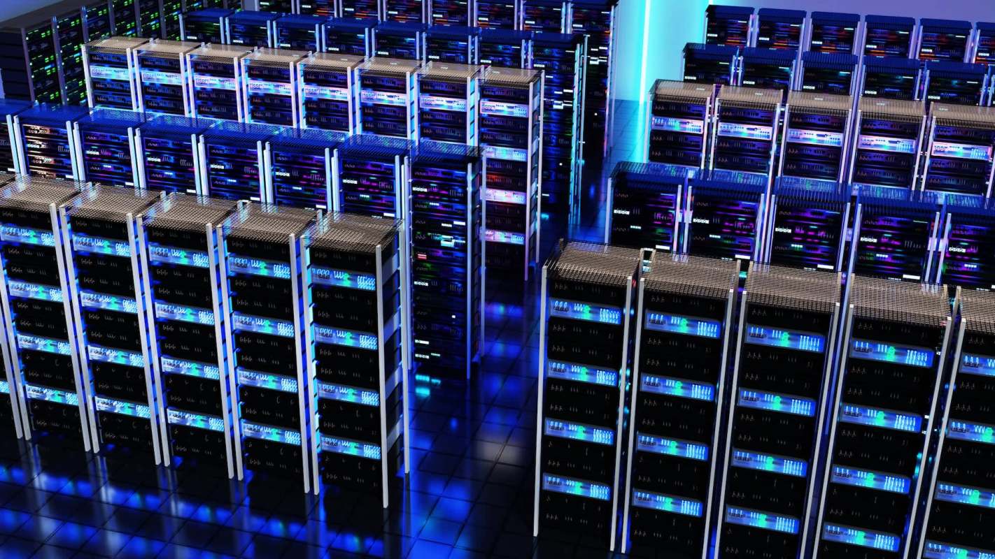 A modern data center featuring rows of servers illuminated with blue and purple lights.