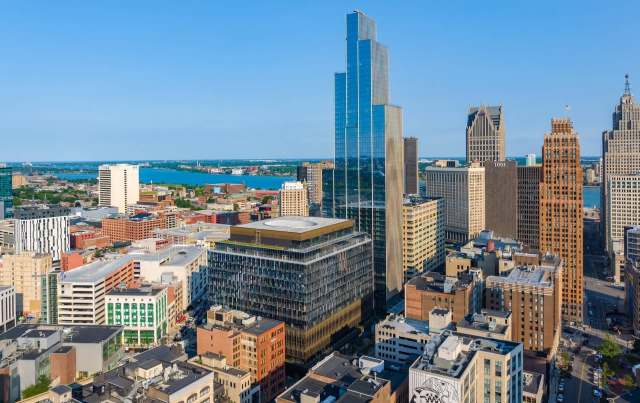 Aerial view of a Detroit development along a waterfront.